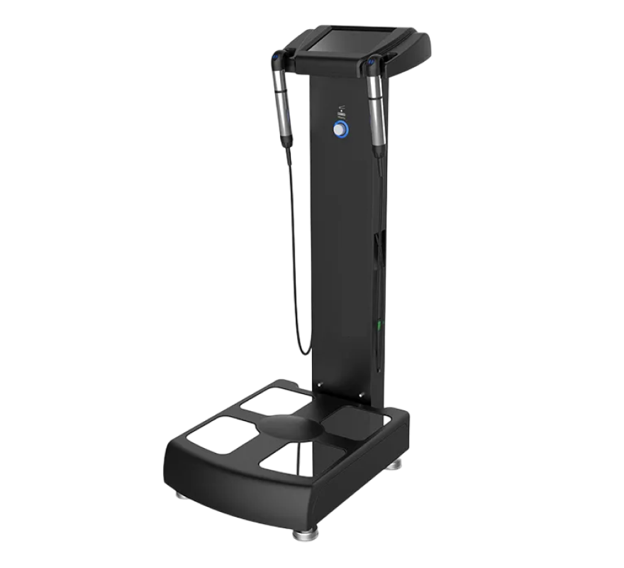 Body composition analyzer machine (bioelectrical impedance analysis device) with standing platform base, vertical pole, handlebar grips, and mounted display screen, shown on transparent background